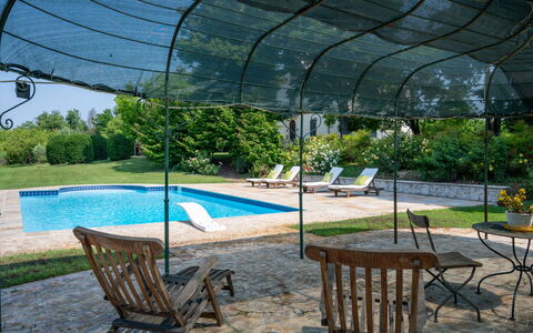 Villa Remotti: Plant, Furniture, Water, Shade, Outdoor Furniture, Chair, Architecture, Tree, Grass, Leisure