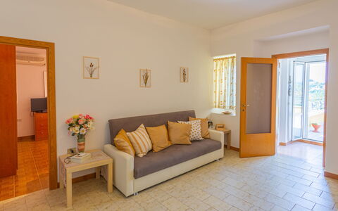 Erika: Furniture, Picture Frame, Table, Plant, Comfort, Houseplant, Building, Couch, Wood, Interior Design