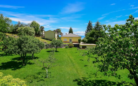 Sandra: Cloud, Plant, Sky, Natural Landscape, Tree, Land Lot, Grass, Cottage, Plain, Building