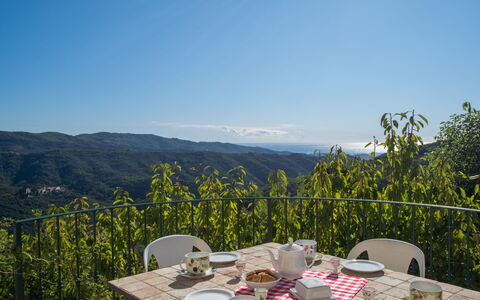 Valloria 605: Sky, Table, Furniture, Dishware, Outdoor Furniture, Outdoor Table, Linens, Tablecloth, Mountain Range, Hill Station