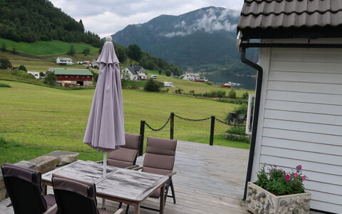 Ikjefjord: Plant, Cloud, Building, Furniture, Property, Green, Mountain, Table, Flowerpot, Sky
