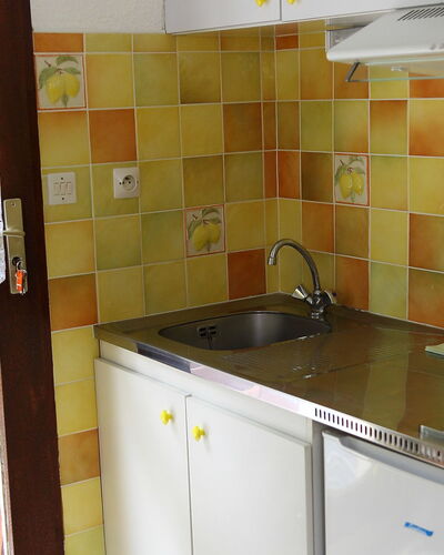 Les Marmottes: Room, Property, Kitchen, Tile, Yellow, Countertop, Furniture, Cabinetry, House, Floor