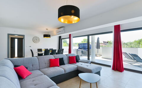 East: Table, Furniture, Couch, Property, Comfort, Lighting, Studio Couch, Living Room, Plant, Interior Design