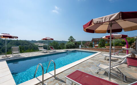 Bricco delle Rondini: Water, Sky, Cloud, Swimming Pool, Plant, Building, Outdoor Furniture, Shade, Sunlounger, Umbrella