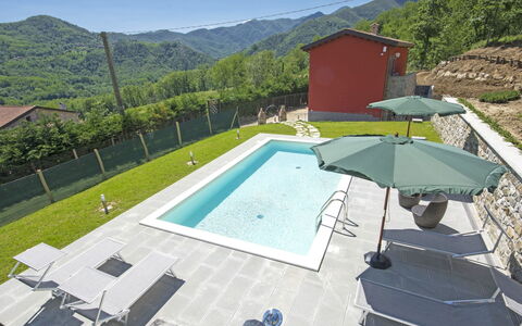 Agr. Castello della Mugazzena: Property, Water, Sky, Swimming Pool, Mountain, Azure, Shade, Tree, Building, Outdoor Furniture