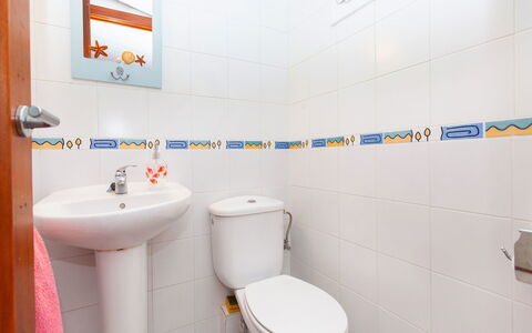 Remedios: Bathroom, Property, Toilet, Room, Toilet Seat, Plumbing Fixture, Wall, Purple, Tile, Interior Design