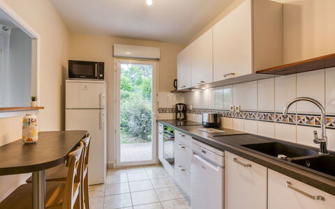 Tassigny: Countertop, Cabinetry, Kitchen Sink, Furniture, Window, Sink, Kitchen Appliance, Kitchen, Wood, Kitchen Stove