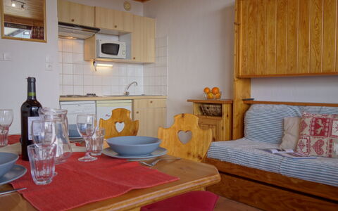 Tignes 395: Table, Furniture, Property, Bottle, Tableware, Cabinetry, Wood, Comfort, Interior Design, Picture Frame