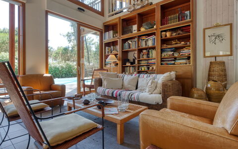 Villa la Lisière des Pins: Furniture, Property, Couch, Bookcase, Table, Shelf, Wood, Interior Design, Living Room, Floor