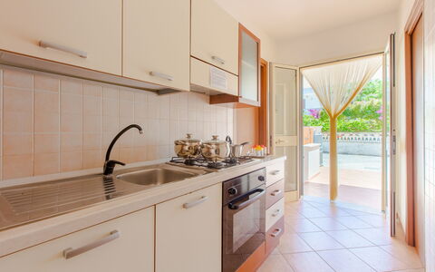 Villa Mezzaluna: Property, Room, Real Estate, Kitchen, Furniture, Building, Cabinetry, House, Interior Design, Yellow