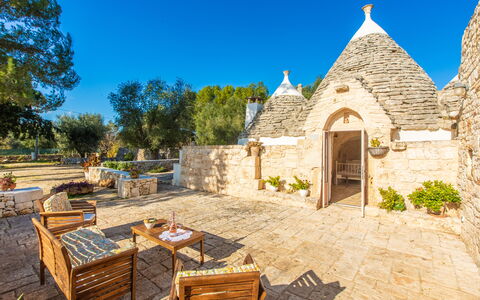 Trullo Con Piscina Per Bambini: Sky, Plant, Furniture, Property, Building, Table, Tree, Chair, Outdoor Furniture, Cottage