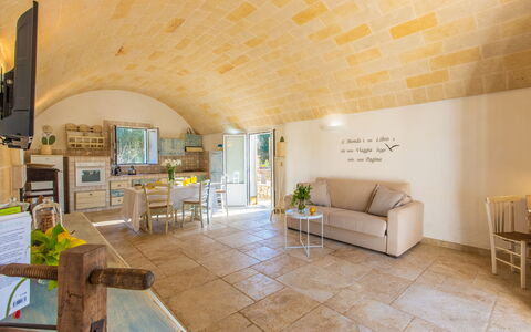 Trullo Con Piscina Per Bambini: Property, Furniture, Couch, Table, Interior Design, Architecture, Flooring, Floor, Living Room, Chair