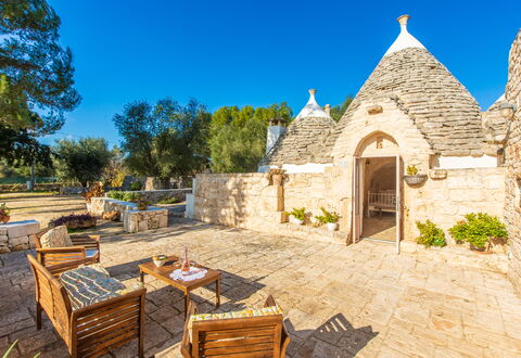 Trullo Con Piscina Per Bambini: Sky, Plant, Furniture, Property, Building, Table, Tree, Chair, Outdoor Furniture, Cottage