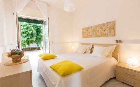 Villa Nettuno: Bedroom, Furniture, Room, Bed, Property, Interior Design, Bed Sheet, Yellow, Bed Frame, Wall