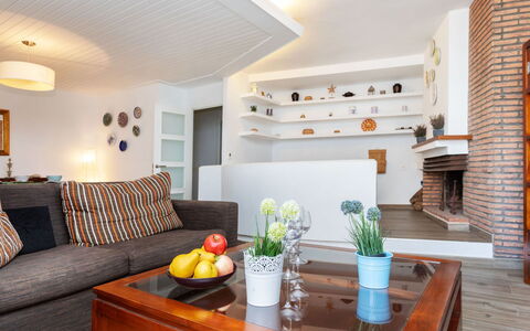 Cap de Tossa: Table, Furniture, Property, Couch, Orange, Interior Design, Wood, Living Room, Plant