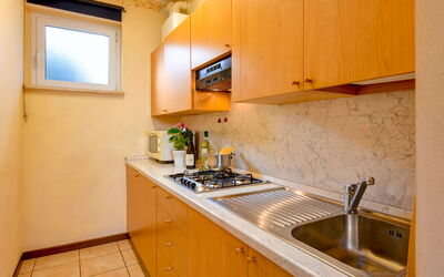 Gardagate - Garda Resort 7: Property, Room, Yellow, Kitchen, Countertop, Sink, Furniture, Building, Real Estate, House