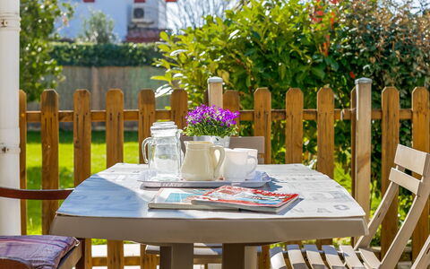Etxe Tikia: Table, Flower, Plant, Furniture, Property, Chair, Outdoor Table, Window, Tableware, Tablecloth