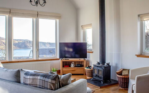 Bay View: Couch, Furniture, Building, Window, Comfort, Azure, Wood, Picture Frame, Television, Interior Design