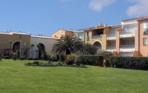 Cap D'Agde 630: Sky, Plant, Cloud, Building, Window, Grass, Urban Design, Tree, Landscape, Facade