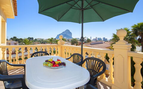 Gao: Table, Furniture, Property, Sky, Green, Chair, Plant, Nature, Umbrella, Building