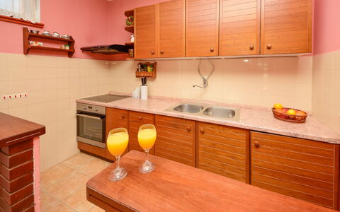 Lolita: Room, Kitchen, Furniture, Property, Countertop, Cabinetry, Orange, Building, Yellow, Interior Design