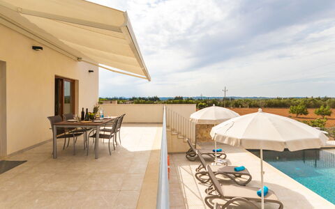 Son Vivot: Sky, Cloud, Furniture, Water, Table, Outdoor Furniture, Shade, Seaside Resort, Umbrella, Chair
