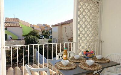 Narbonne-Plage 120: Table, Sky, Property, Furniture, Building, Tableware, Chair, Plant, Shade, Wood