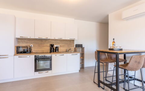 Porto Vecchio 116: Cabinetry, Property, Countertop, Furniture, Building, Wood, Kitchen Stove, Kitchen, Table, Interior Design
