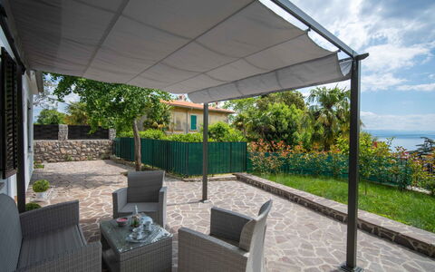 Erminia: Plant, Cloud, Property, Building, Sky, Shade, Outdoor Furniture, Interior Design, Cottage, Grass