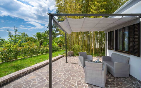 Erminia: Plant, Furniture, Cloud, Sky, Shade, Tree, Building, Chair, Outdoor Furniture, Road Surface