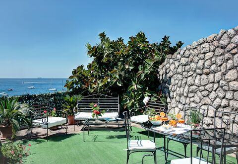 La Baia Dello Chalet: Sky, Plant, Property, Water, Furniture, Table, Nature, Chair, Outdoor Furniture, Shade