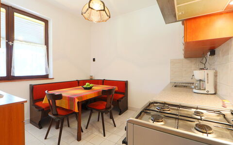 Akazie: Furniture, Property, Window, Cabinetry, Table, Gas Stove, Exhaust Hood, Wood, Chair, Orange