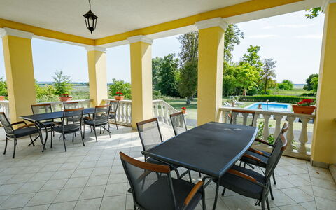 Zichy: Table, Furniture, Plant, Chair, Shade, Wood, Interior Design, Architecture, Sky, Porch