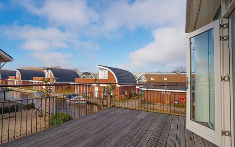 Penthouse: Composite Material, Door, Deck, Wood Stain, Brick, Hardwood, Daylighting, Balcony, Siding, Houseplant