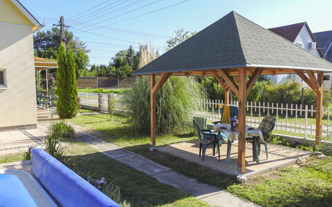 Sunny Day: Roof, Garden, Shade, Cottage, Outdoor Structure, Lawn, Backyard, Landscaping, Yard, Gazebo