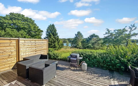Kirsikkaranta 1: Sky, Outdoor Furniture, Hardwood, Deck, Plank, Garden, Shade, Wood Stain, Landscaping, Chair
