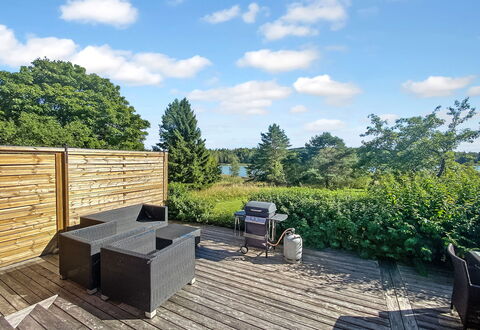 Kirsikkaranta 1: Sky, Outdoor Furniture, Hardwood, Deck, Plank, Garden, Shade, Wood Stain, Landscaping, Chair