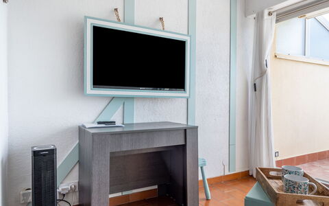 Les Jardins de la Plage: Furniture, Building, Table, Computer Desk, Window, Television, Cabinetry, Wood, Interior Design