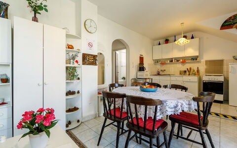 Csilla: Table, Furniture, Plant, Picture Frame, Property, Flower, Interior Design, Building, Chair, Houseplant