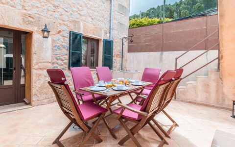 Boutique House: Furniture, Table, Window, Building, Chair, Wood, Purple, Sky, Outdoor Table, Outdoor Furniture