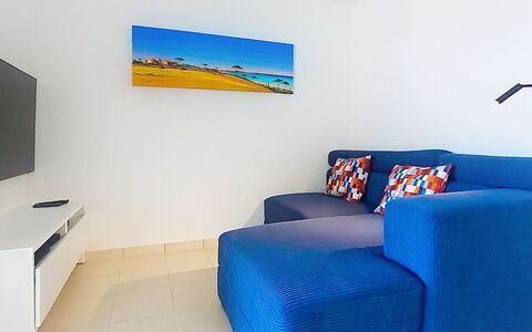 Les Grenadines: Blue, Furniture, Apartment, Floor, Couch, Living Room, Sofa Bed, Armrest, Coffee Table