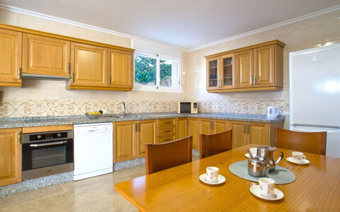 Villa Delfín: Table, Cabinetry, Property, Countertop, Furniture, Building, Wood, Kitchen, Lighting, Interior Design