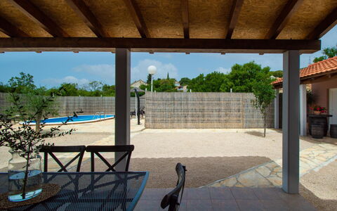 Nina: Sky, Property, Shade, Tree, Chair, Building, Leisure, Outdoor Furniture, Plant, Landscape
