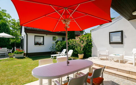 Suzy: Table, Plant, Furniture, Property, Building, Chair, Flowerpot, Umbrella, Shade, Houseplant