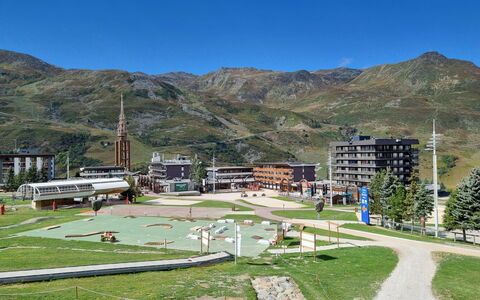 Les Menuires 694: Sky, Building, Ecoregion, Mountain, Cloud, Plant, Infrastructure, Land Lot, Urban Design, Grass