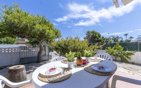 D1: Sky, Cloud, Plant, Building, Property, Table, Furniture, Flowerpot, Tableware, Outdoor Furniture