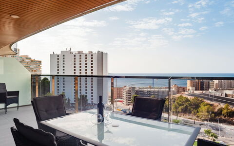 Sunset Waves: Table, Building, Sky, Furniture, Cloud, Property, Water, Chair, Interior Design, Window