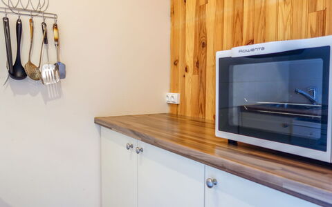 Tignes 220: Cabinetry, Property, Countertop, Kitchen Appliance, Wood, Interior Design, Building, Floor, Microwave Oven, Television Set
