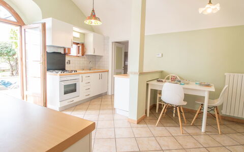 Kiwi e L'Uva - Tuscia: Furniture, Cabinetry, Countertop, Exhaust Hood, Kitchen, Table, Lighting, Chair, Wood, Kitchen Stove