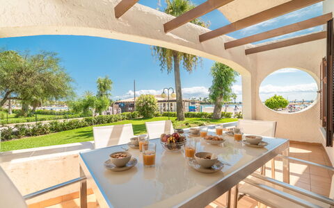 Carabela Front Beach & Pool: Table, Sky, Property, Furniture, Tableware, Plant, Chair, Building, Flowerpot, Shade